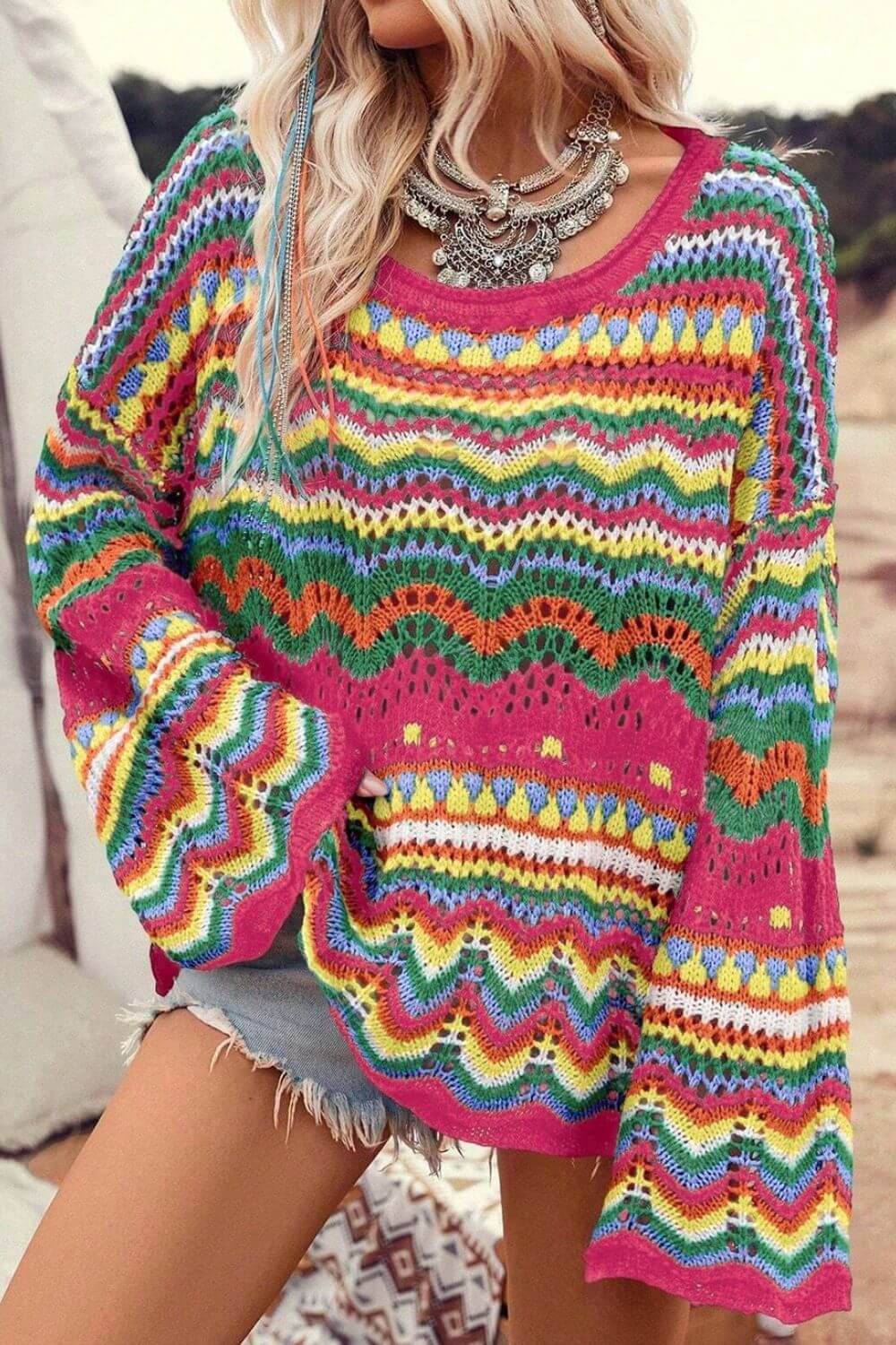 Woman wearing colorful openwork knit sweater with long sleeves, ideal for winter wardrobe, women's winter clothes.