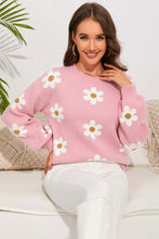 Load image into Gallery viewer, Woman wearing pink flower sweater with round neck and dropped shoulders, perfect winter clothes for women, sitting on a couch and smiling.
